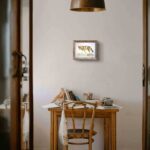 A red wolf artwork hanging above a table